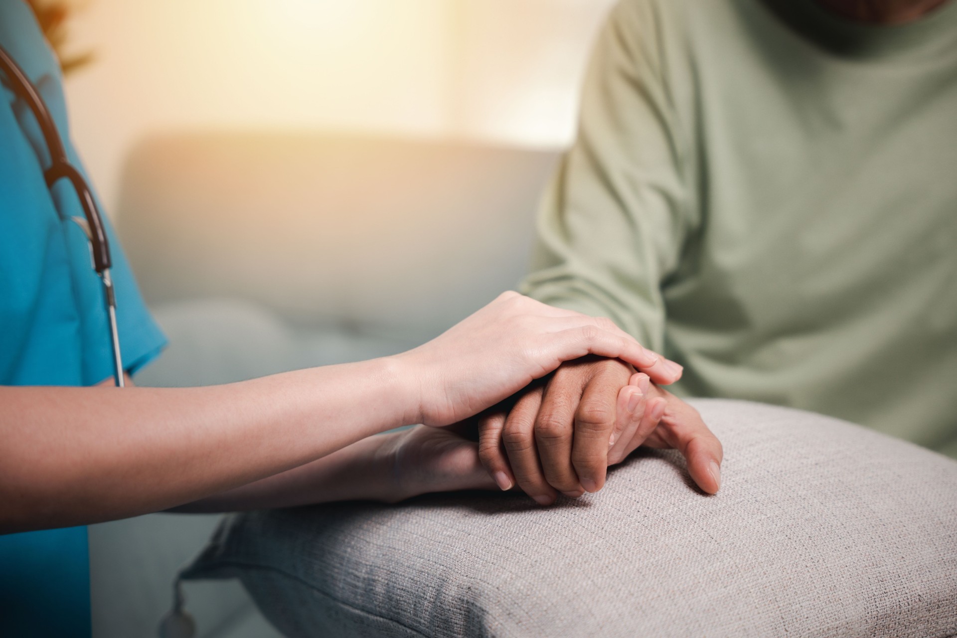 Caring nurse helping elderly old man care facility gets help